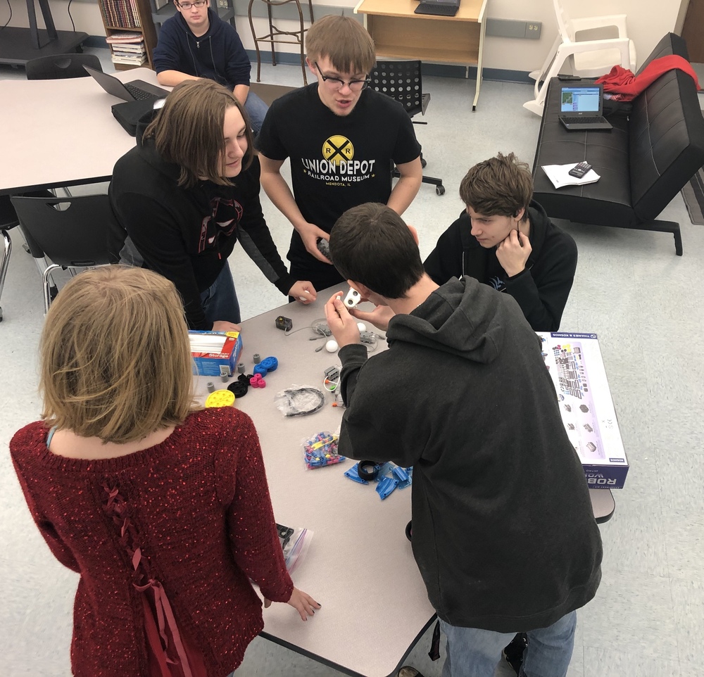 Students working on a small robot.